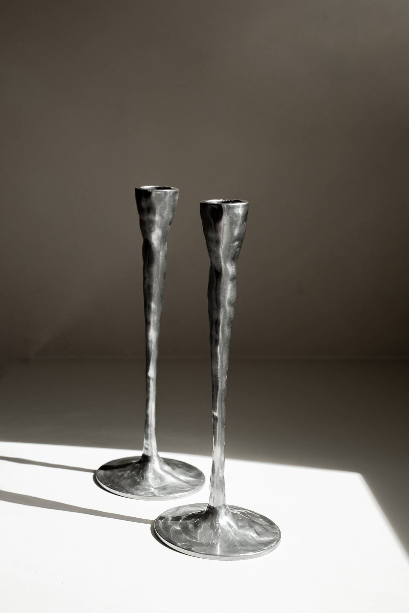 Pair of aluminium candle holders