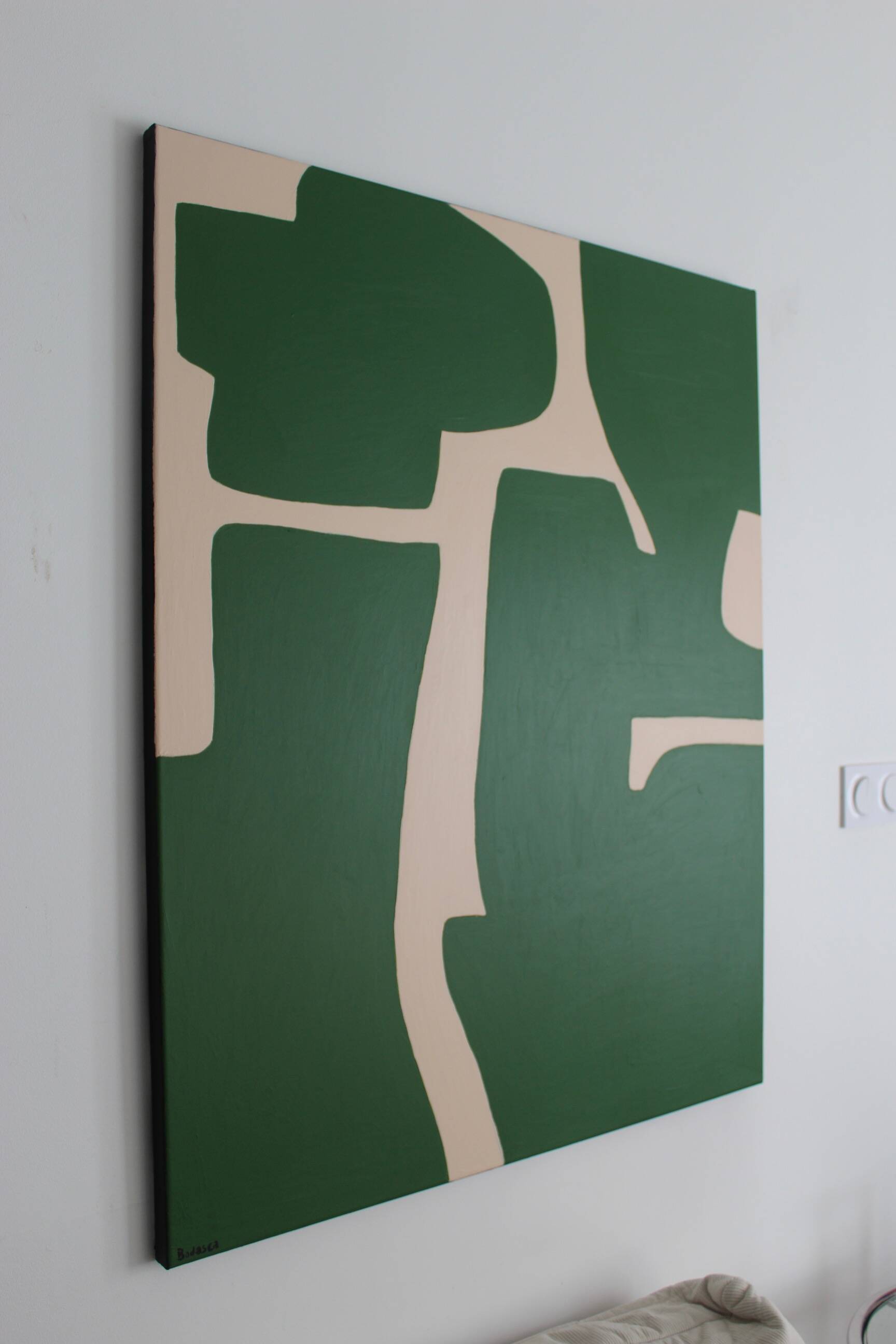 Abstract green art on a beige background.