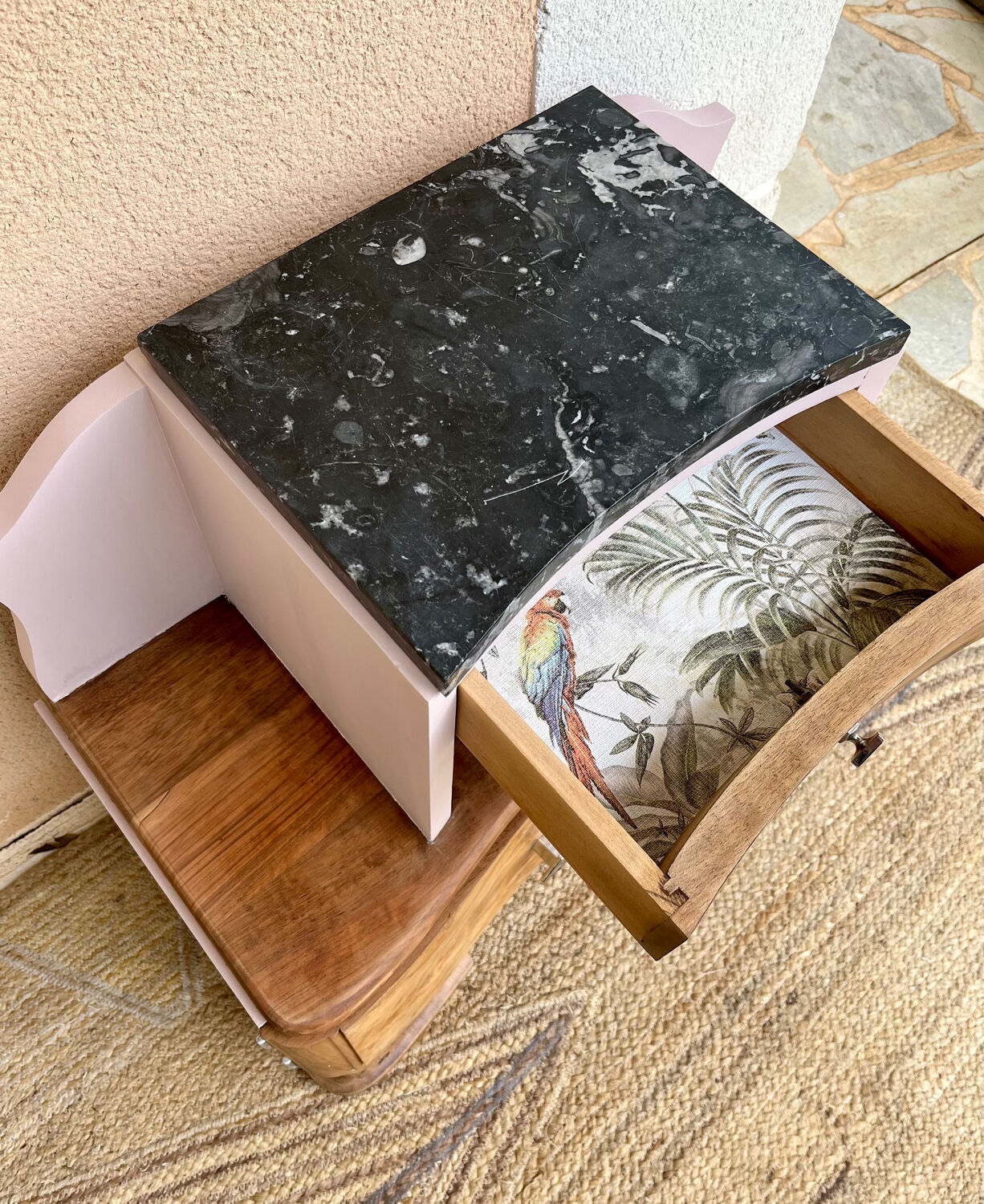 Art Deco bedside table in powder pink painted wood.