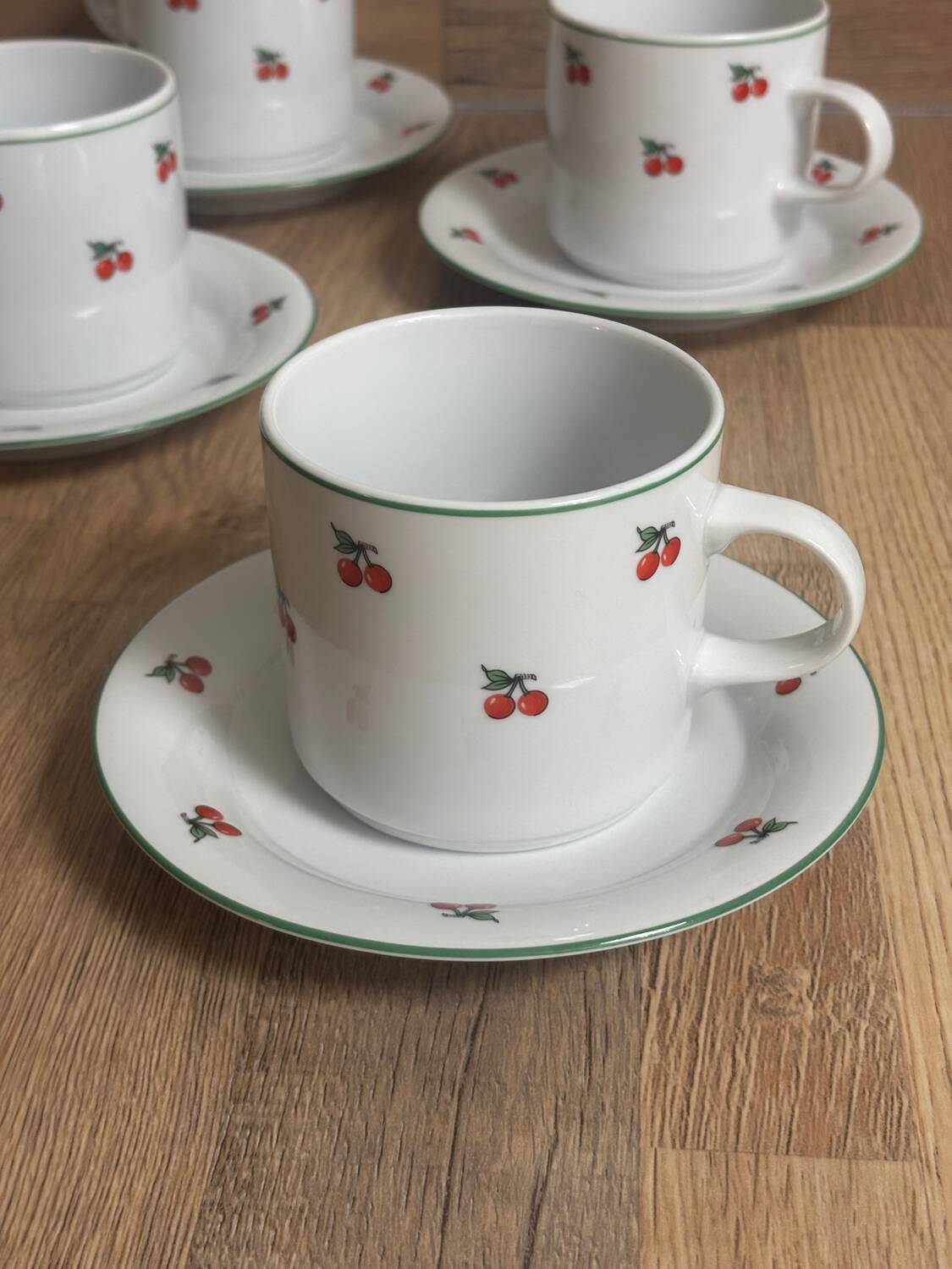 Set of 4 large cherry porcelain cups and saucers.