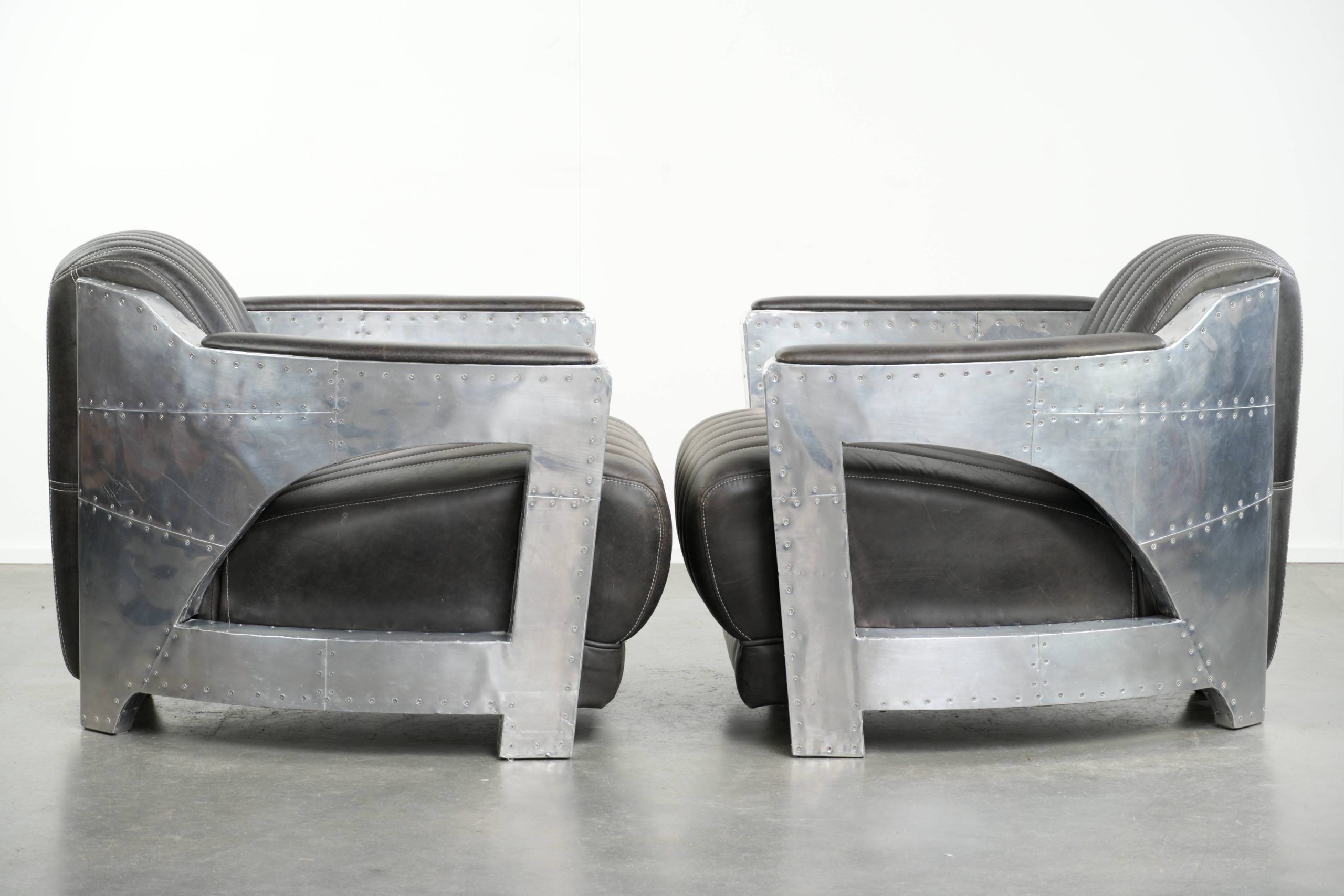 Set of 2 sturdy industrial black cowhide Aviator design armchairs with aluminium and rivets