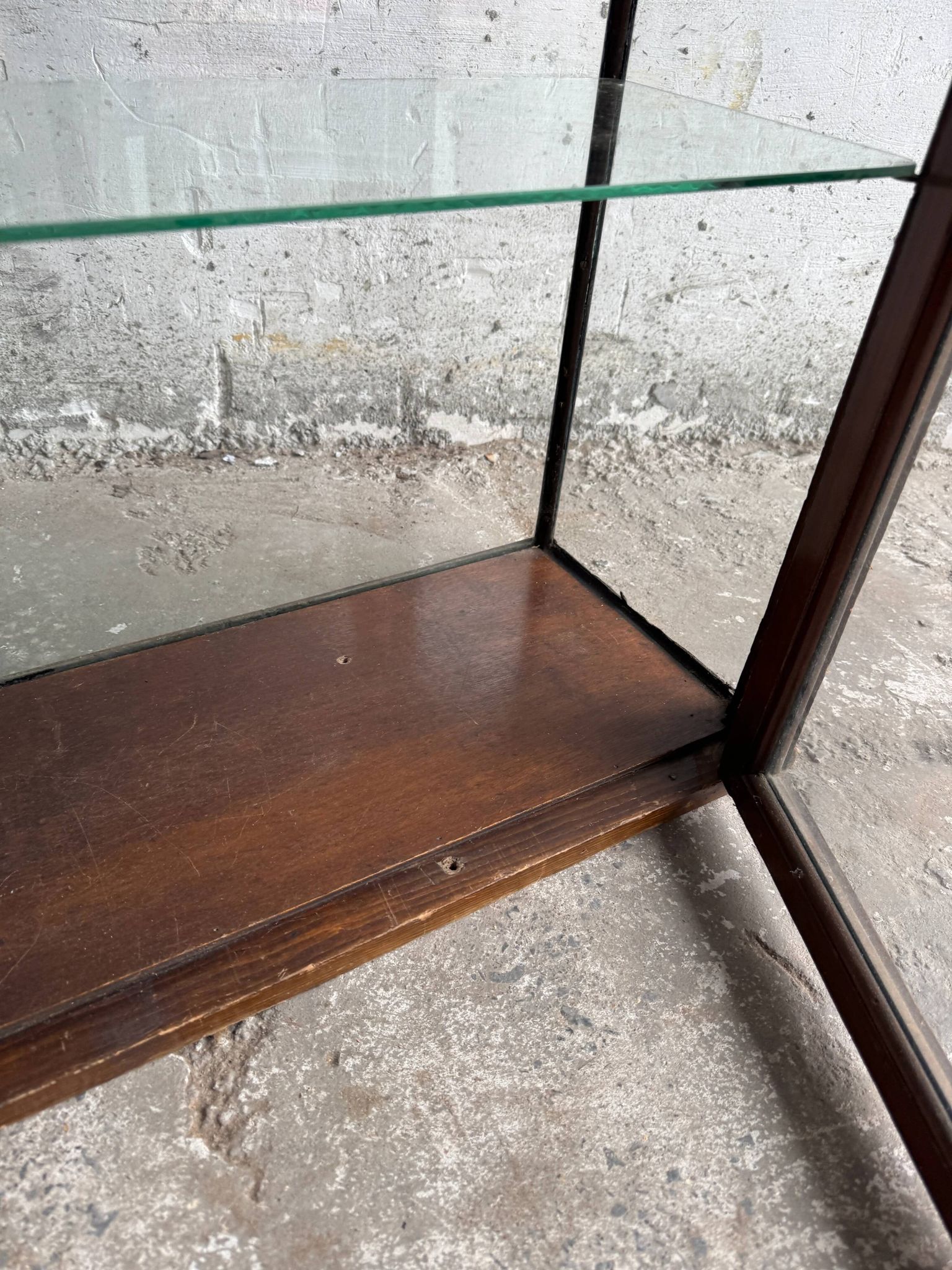 Dark-stained wood and glass vintage display cabinet — early 20th-century wall-mounted showcase