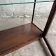 Dark-stained wood and glass vintage display cabinet — early 20th-century wall-mounted showcase