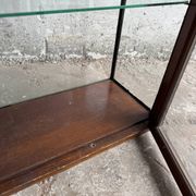 Dark-stained wood and glass vintage display cabinet — early 20th-century wall-mounted showcase