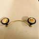Gold and black metal coatrack 1960
