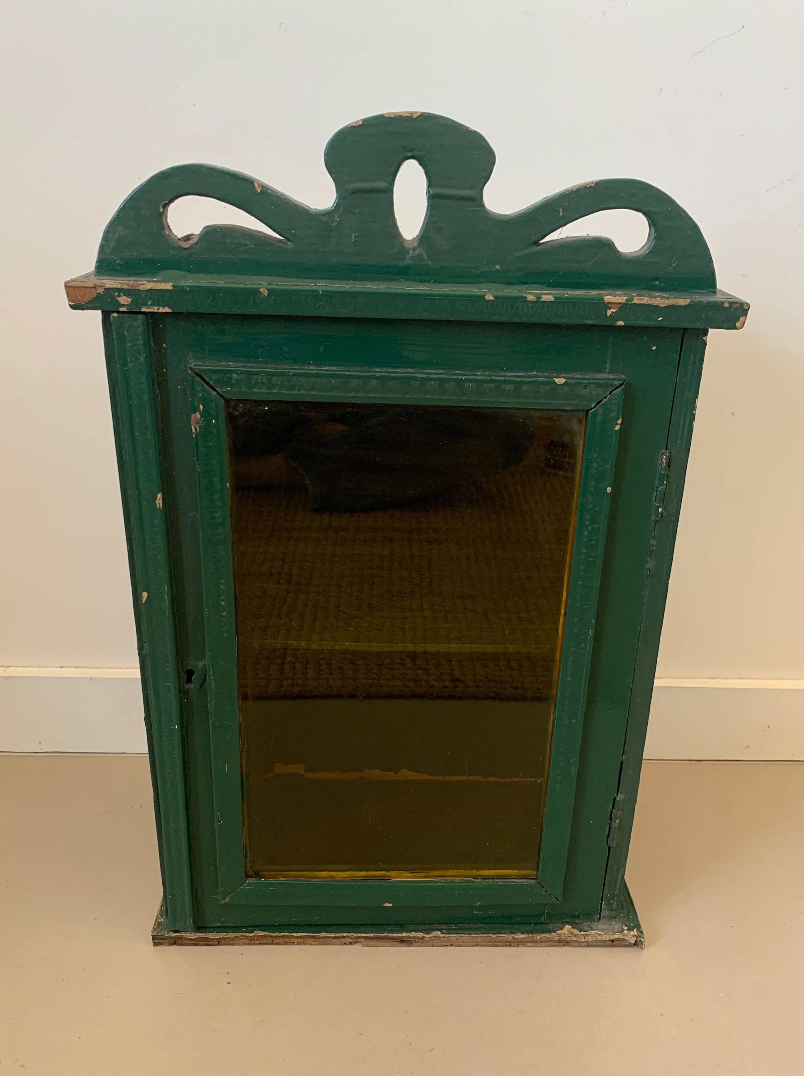 Wall vitrin with pediment