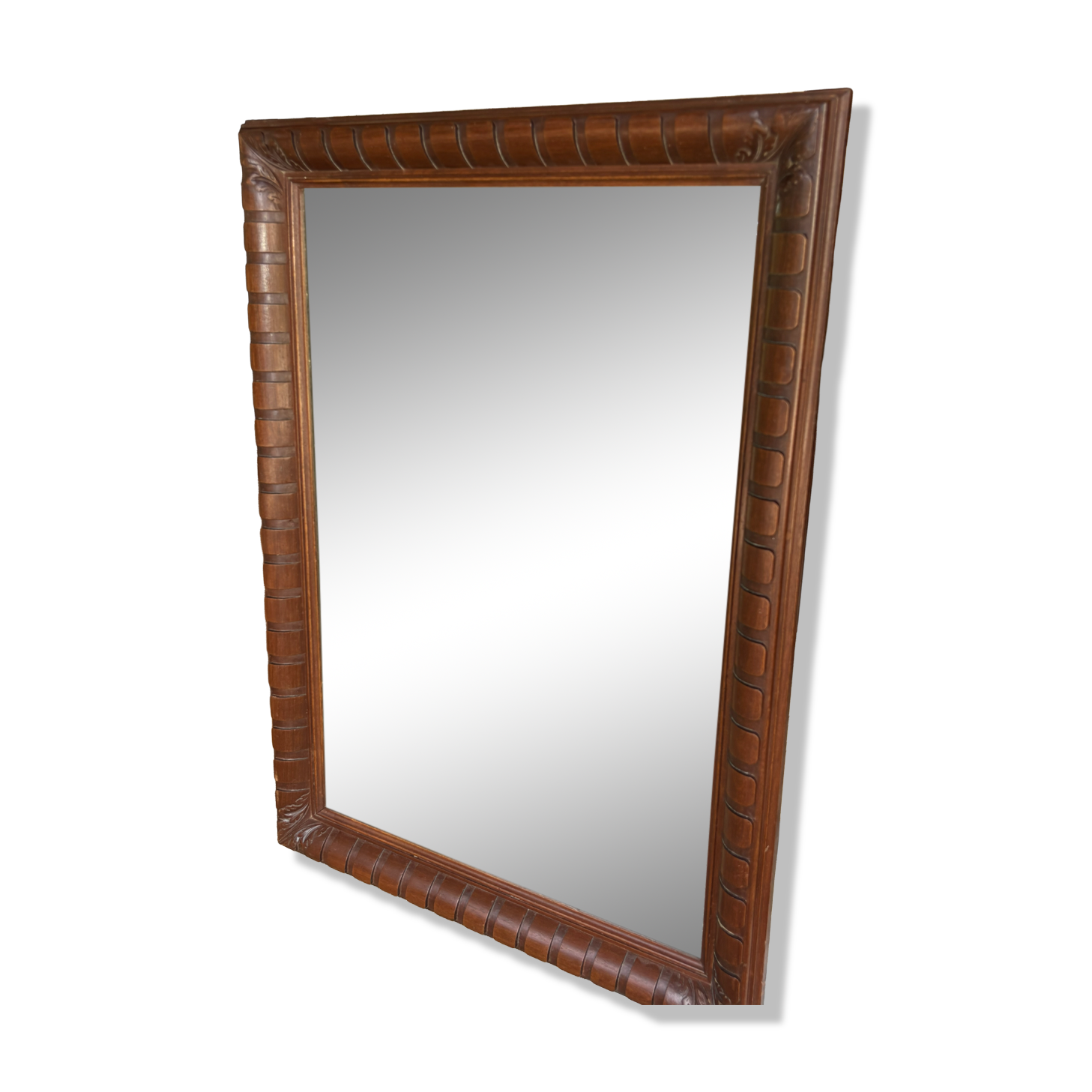 Large wall mirror with an elegant wooden frame.