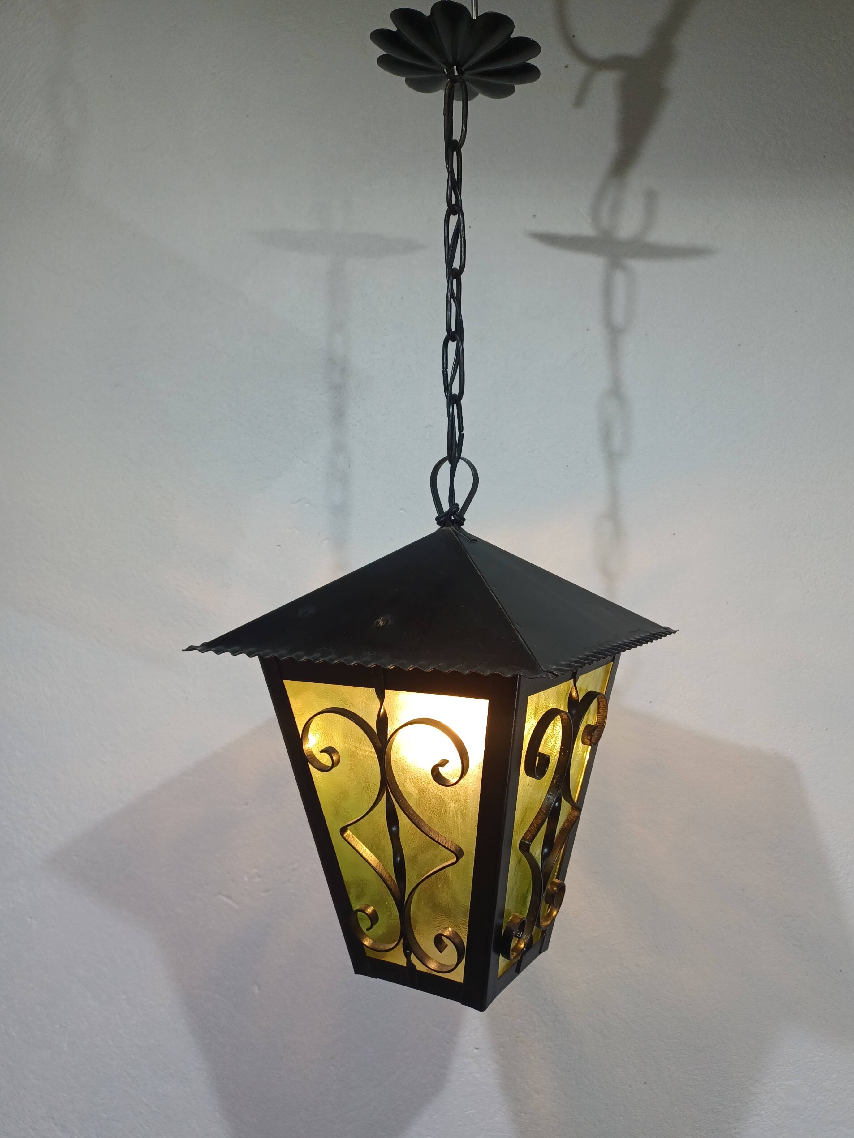 Wrought iron and green glass lantern