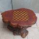 Brutalist chessboard coffee table made from tree stump.
