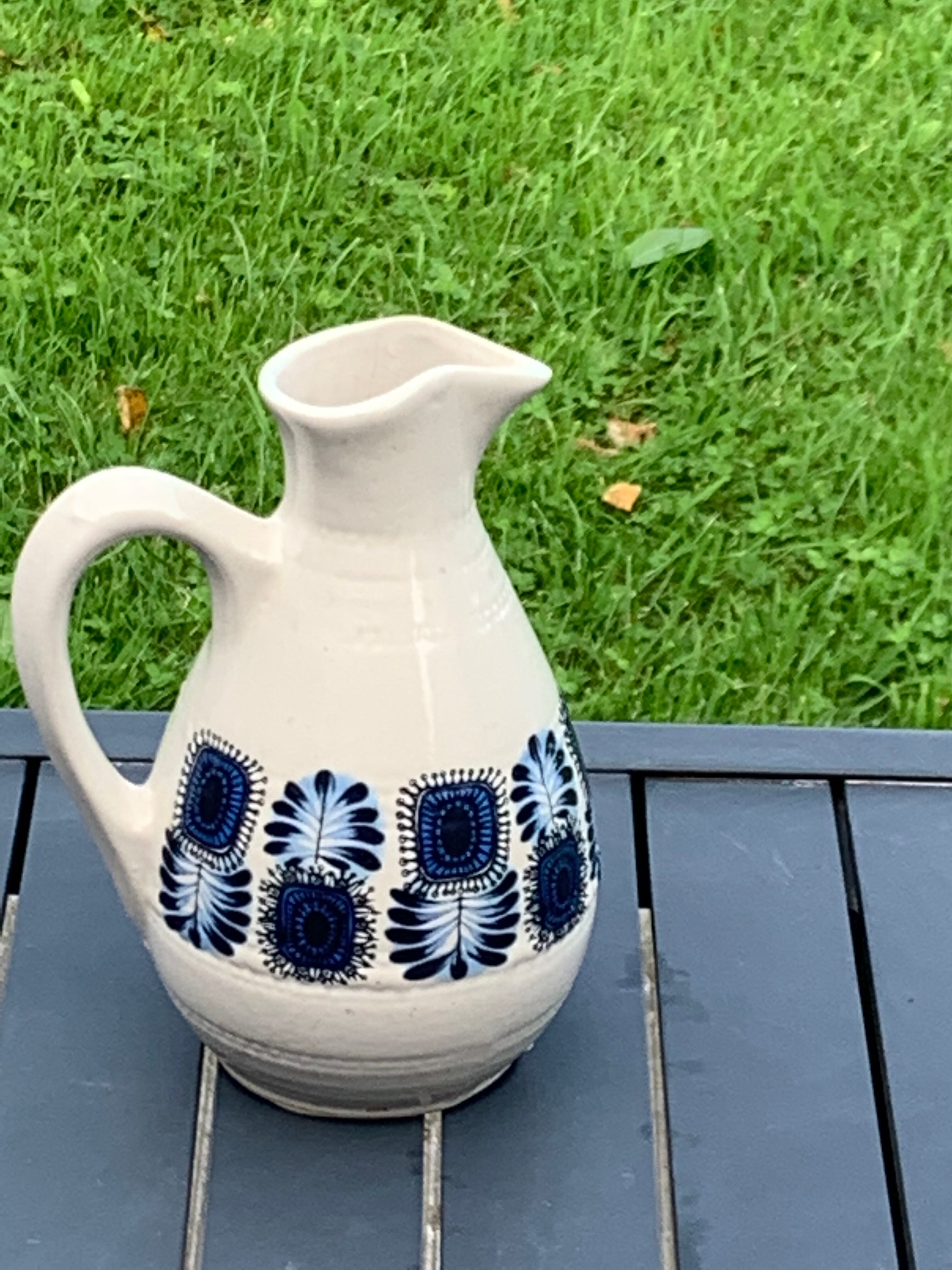 Enamelled sandstone carafe with a nice pattern of vintage blue flowers and 1970 design
