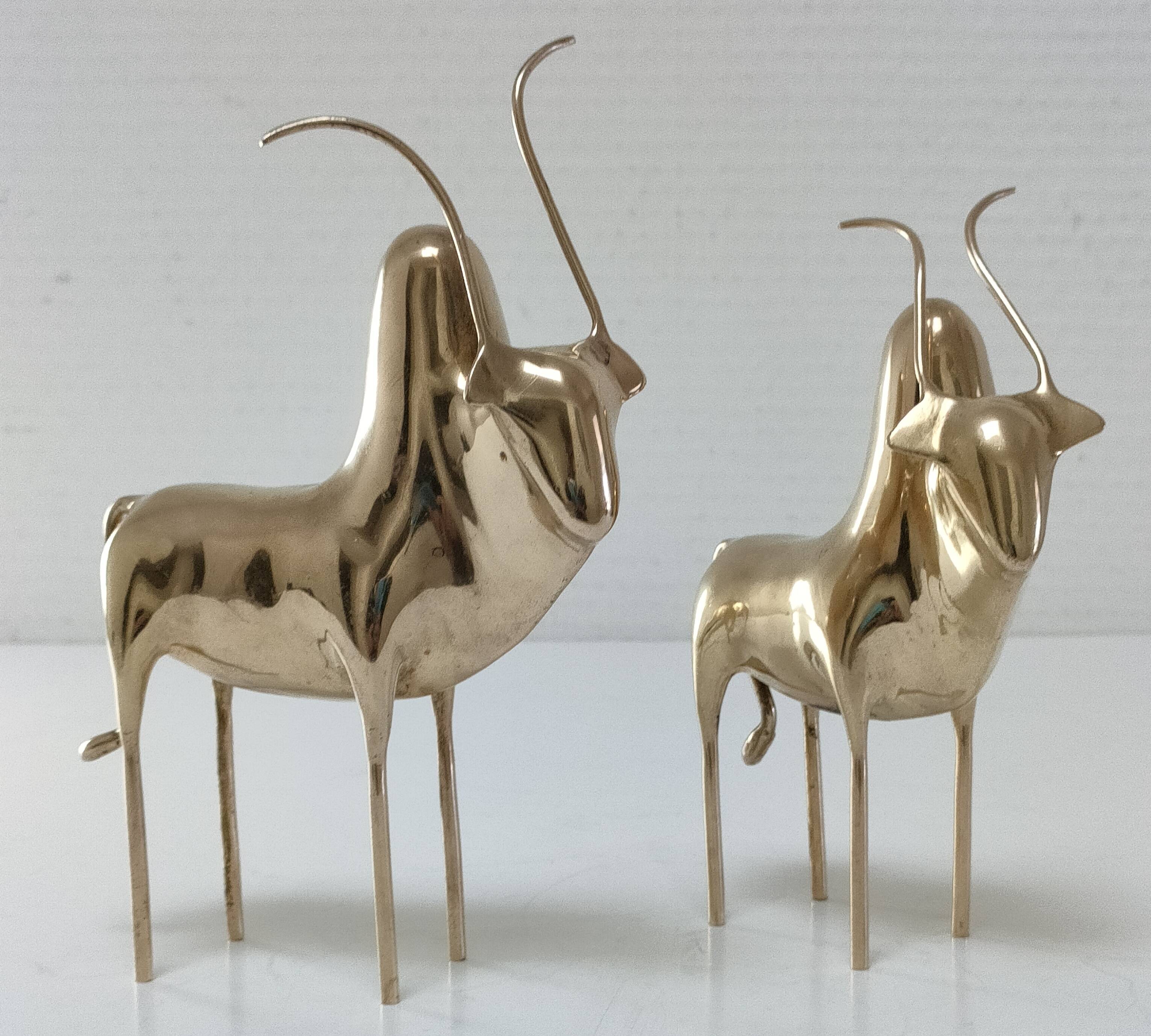 Two stylized zebu with long vintage brass horns