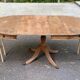 Round extendable dining table Regency central leg stripped mahogany 1960