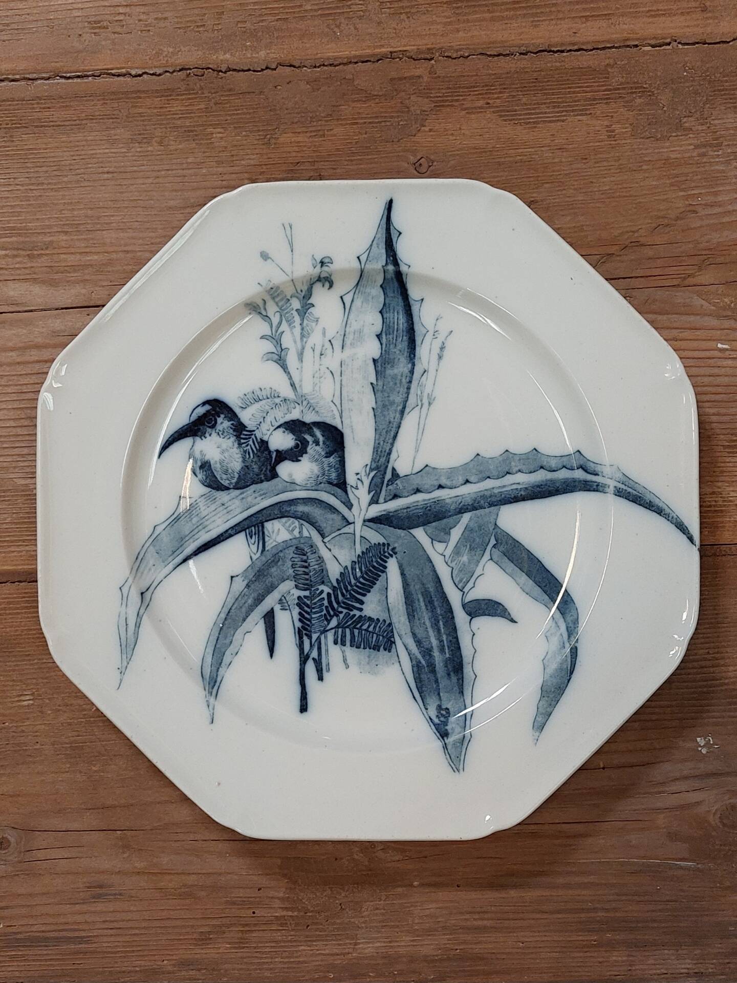 Set of three ironstone plates decorated with birds.