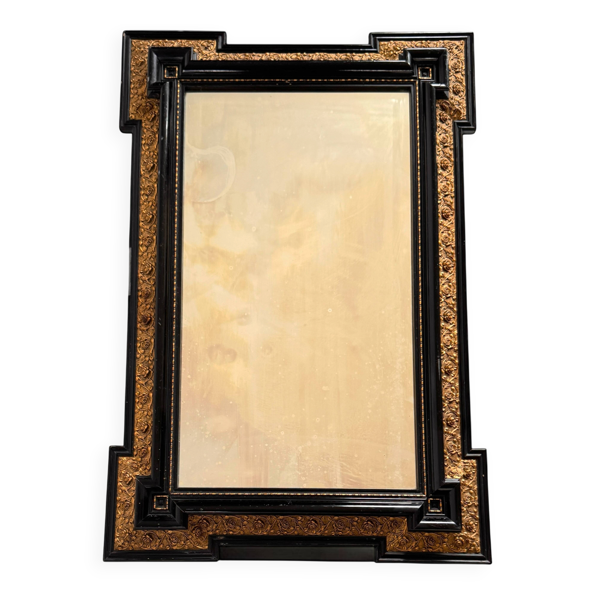 Antique wall mirror in blackened wood and gilded stucco, 19th-century Dutch style.