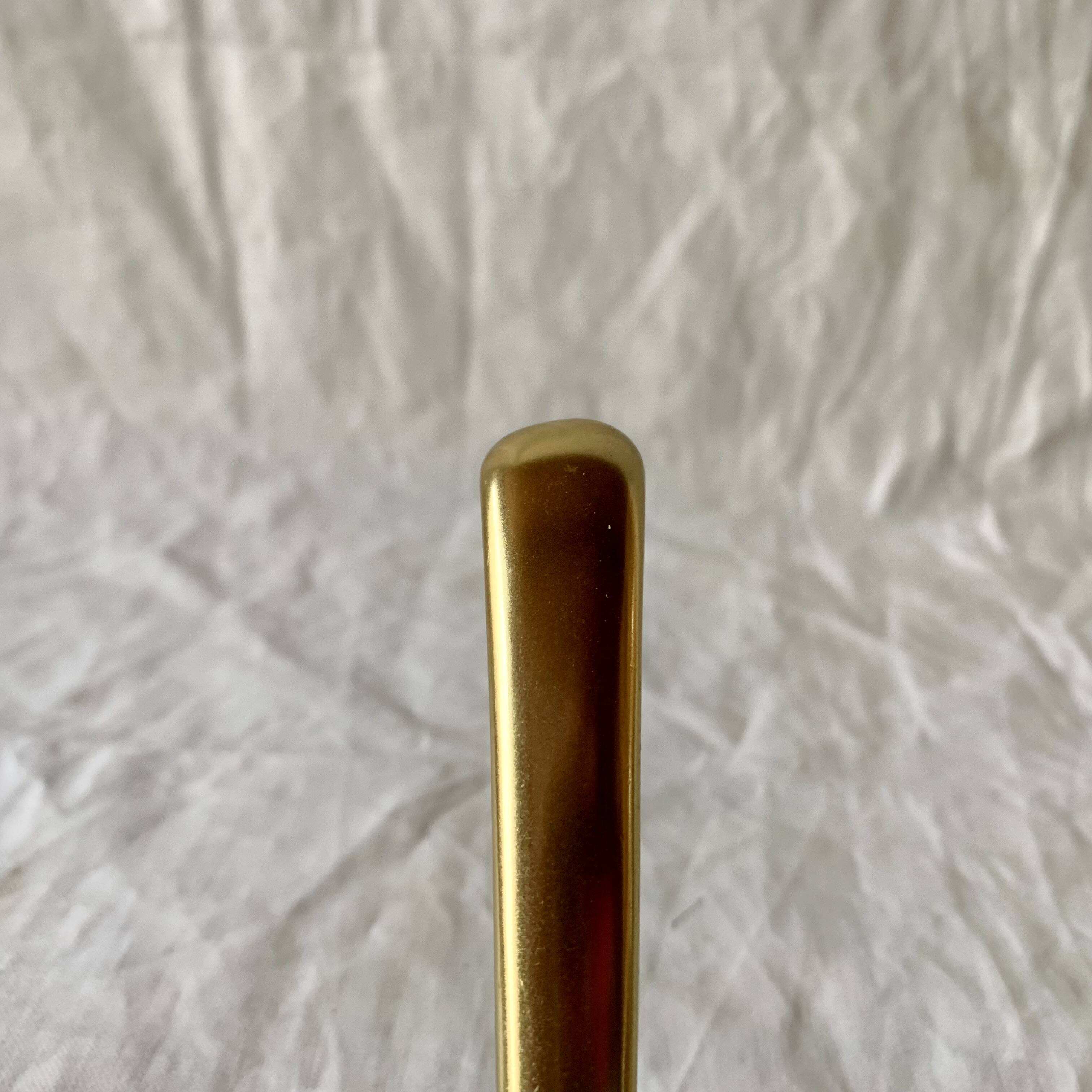 Vintage coat rack in lacquered metal with three golden aluminum hooks