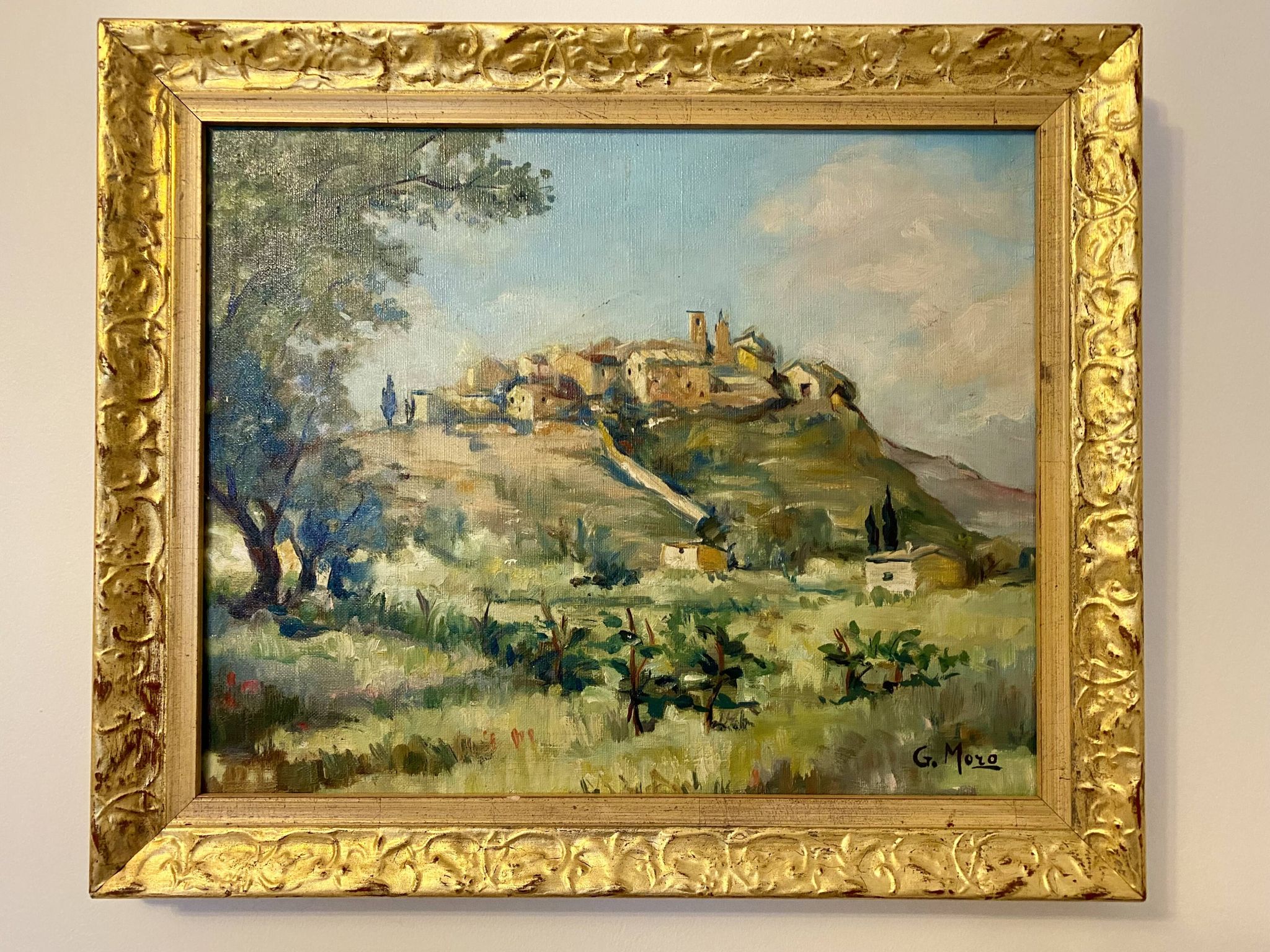 A painting representing a village in Tuscany.