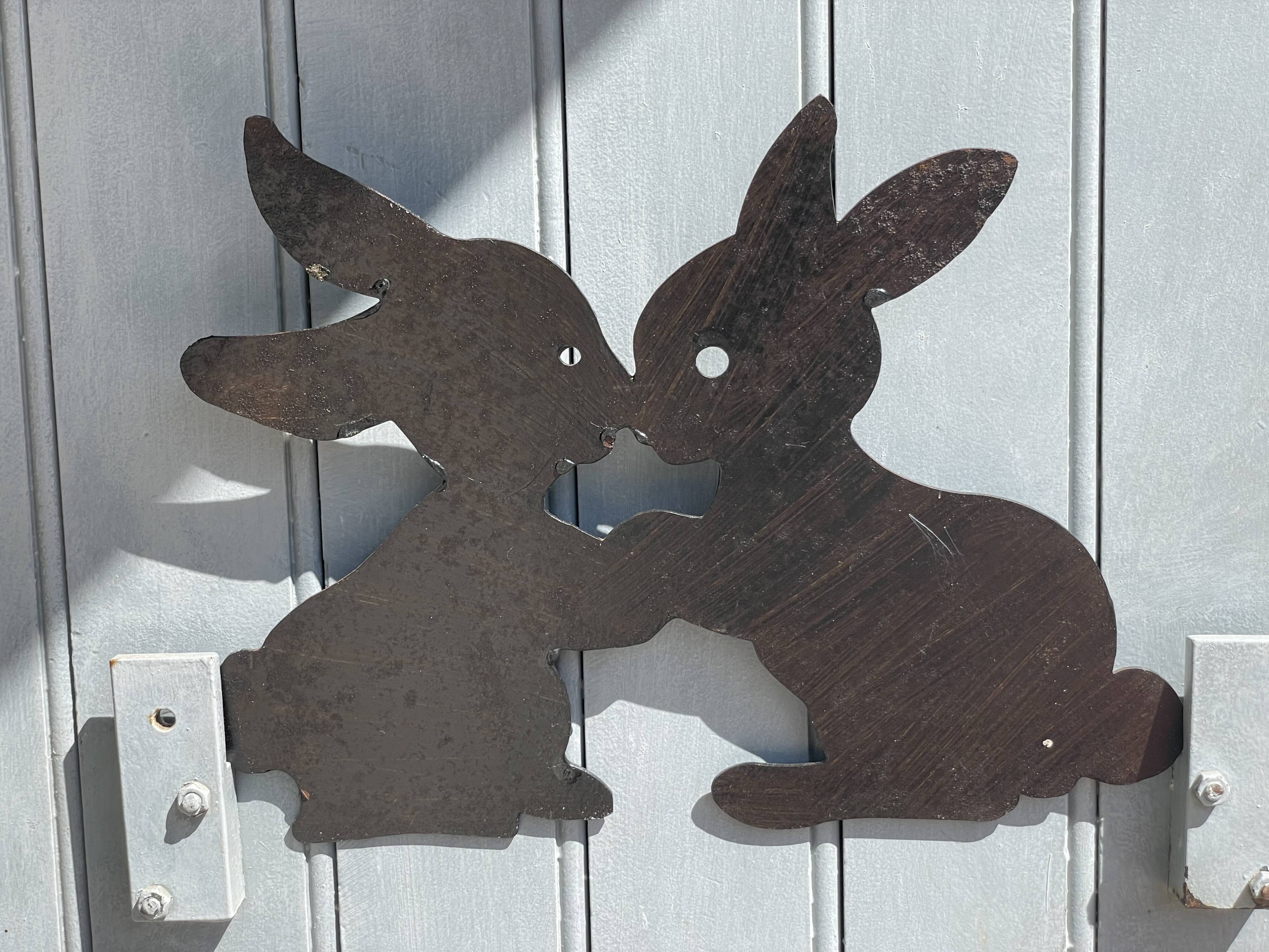 Cast iron plate in the shape of rabbits