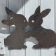 Cast iron plate in the shape of rabbits