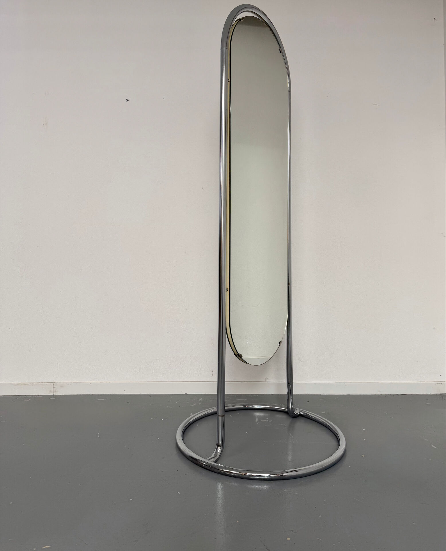 Large freestanding chrome metal full-length mirror in 1970s design.