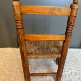 Old, rustic children's chair, small wooden and straw chair.