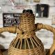 Braided wicker green bottle