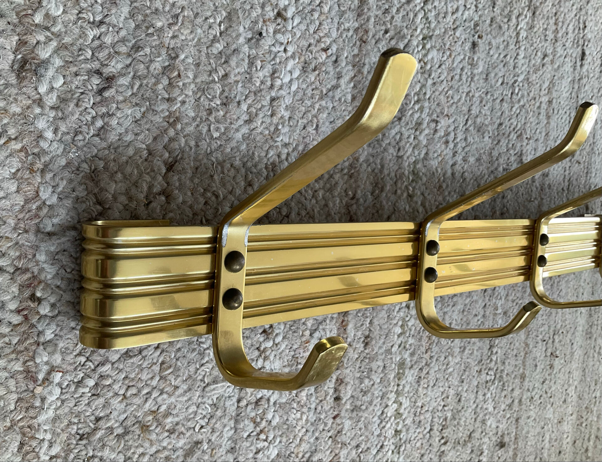 Golden wall-mounted coat rack from the 70s.