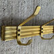 Golden wall-mounted coat rack from the 70s.