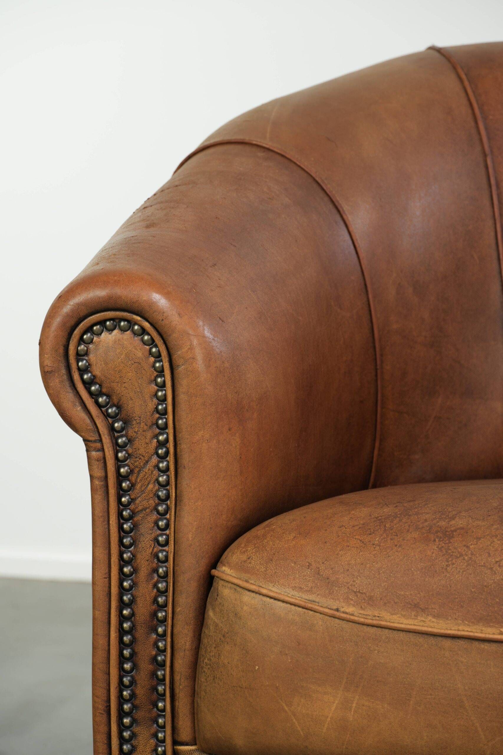 Aged sheepskin clubchair with beautiful vintage patina and comfortable seat