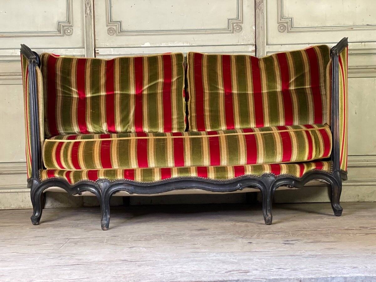 Louis XV style sofa in carved wood with a black patina