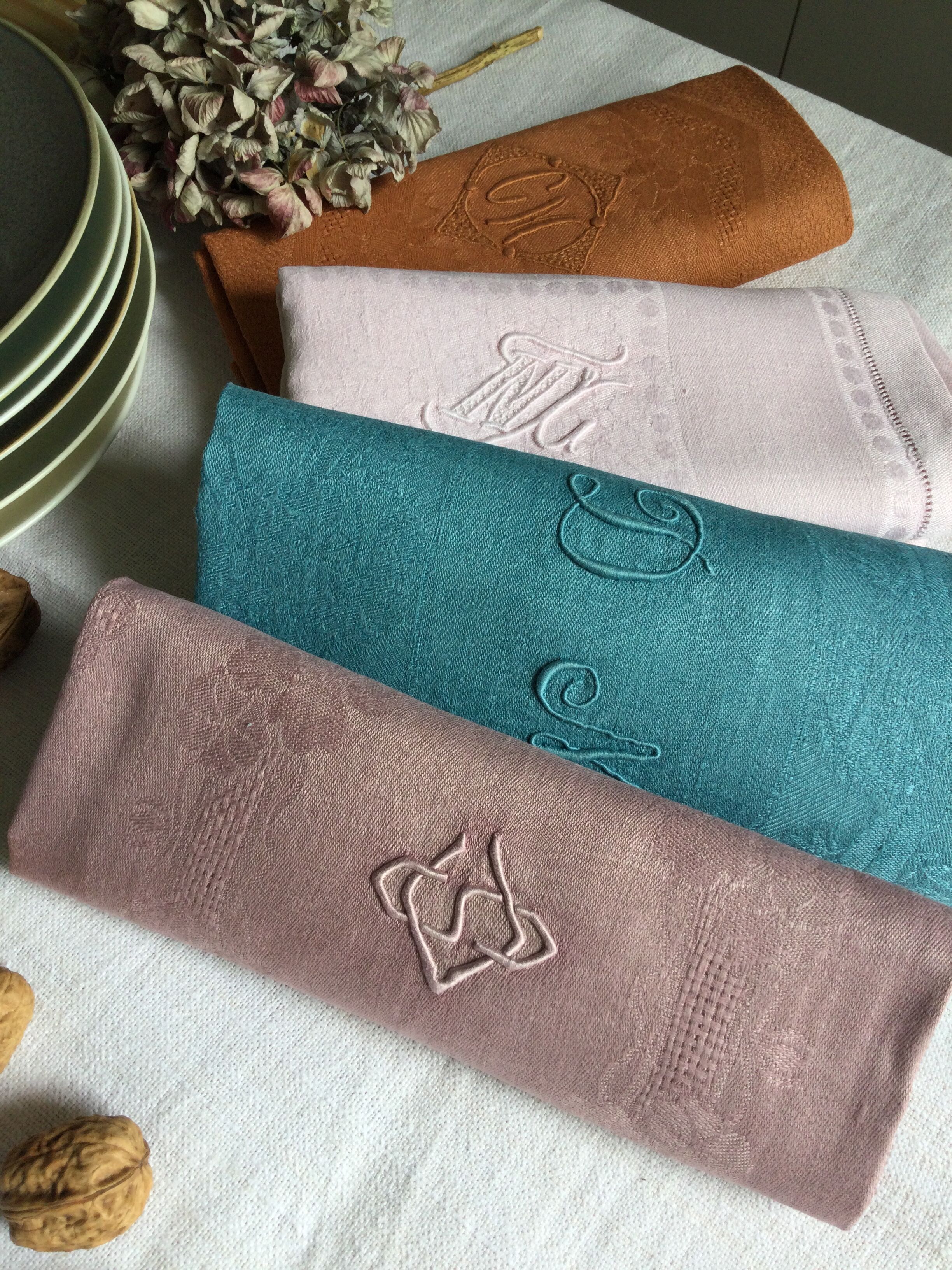 Set of four old damask towels tinted in multiple colors