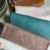 Set of four old damask towels tinted in multiple colors