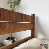 Brutalist style bed with chain and straw
