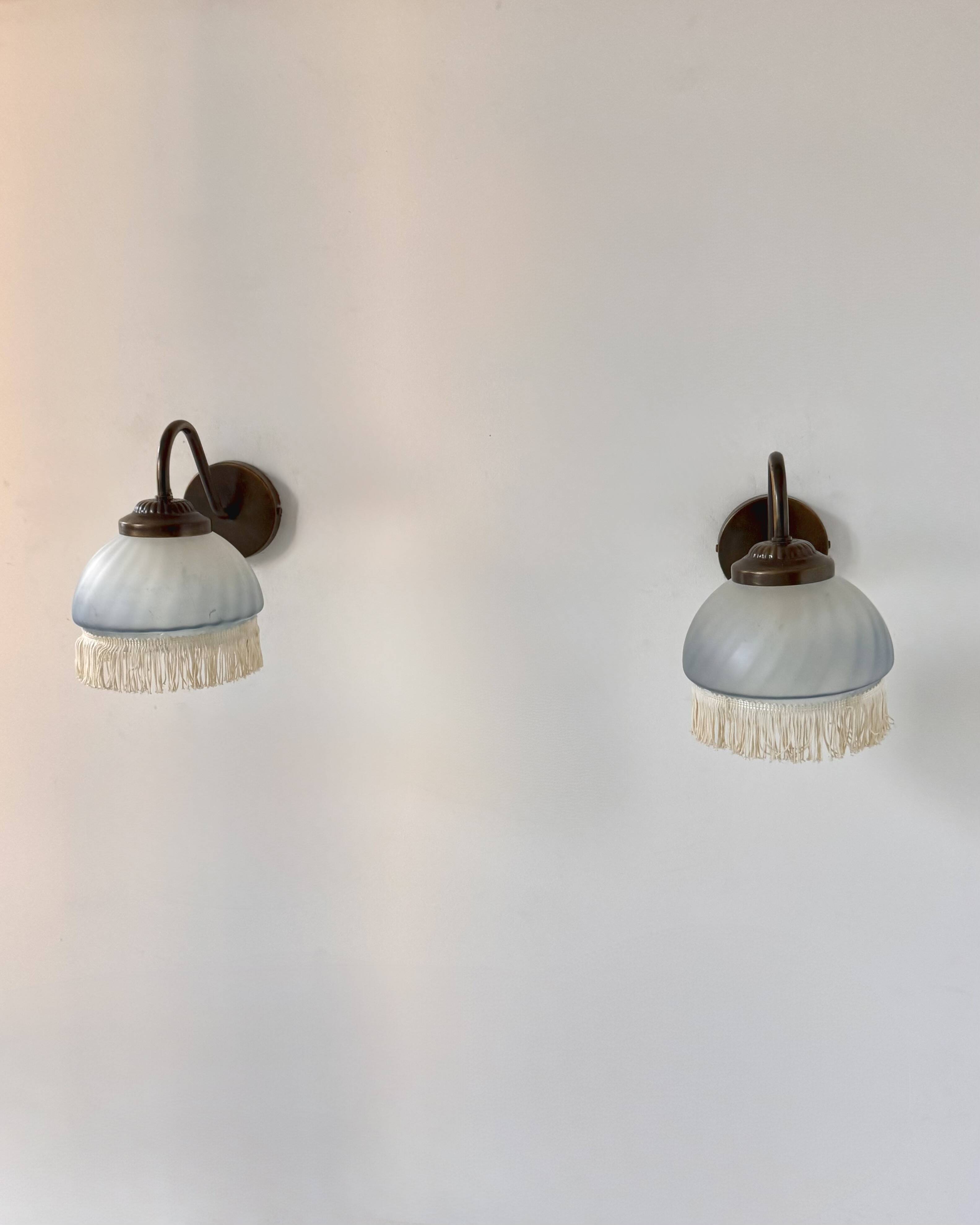 Pair of vintage wall lights in brass and blue-tinted glass, France 1970.