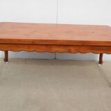 Large solid wood table with integrated extensions.