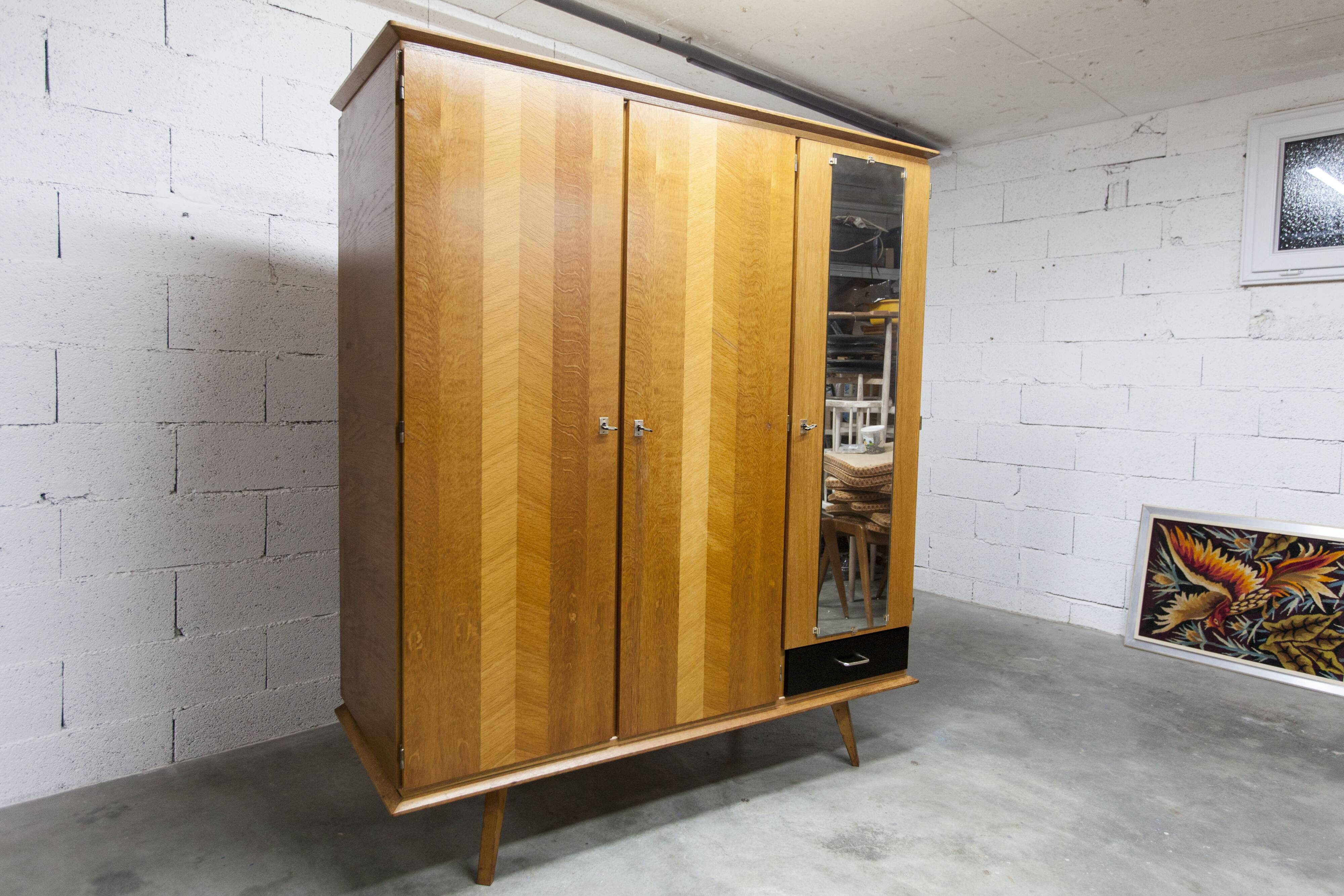 French wardrobe with tapered legs, 3 doors, 1 mirror (27*130), and 1 drawer.