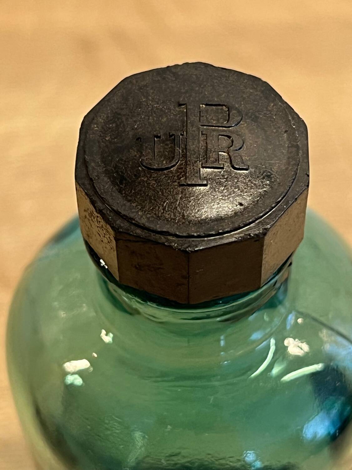 Small vintage dark turquoise blue bottle