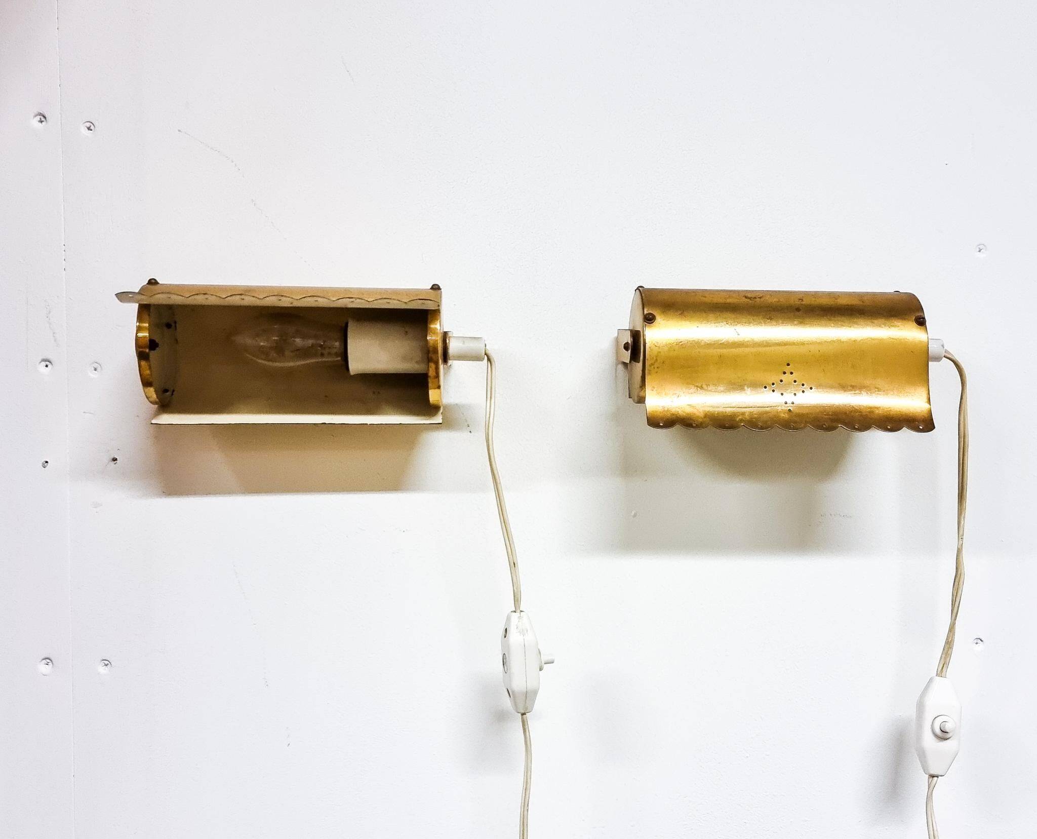 A pair of charming wall sconces/branches in brass with a star pattern, modern Scandinavian style.