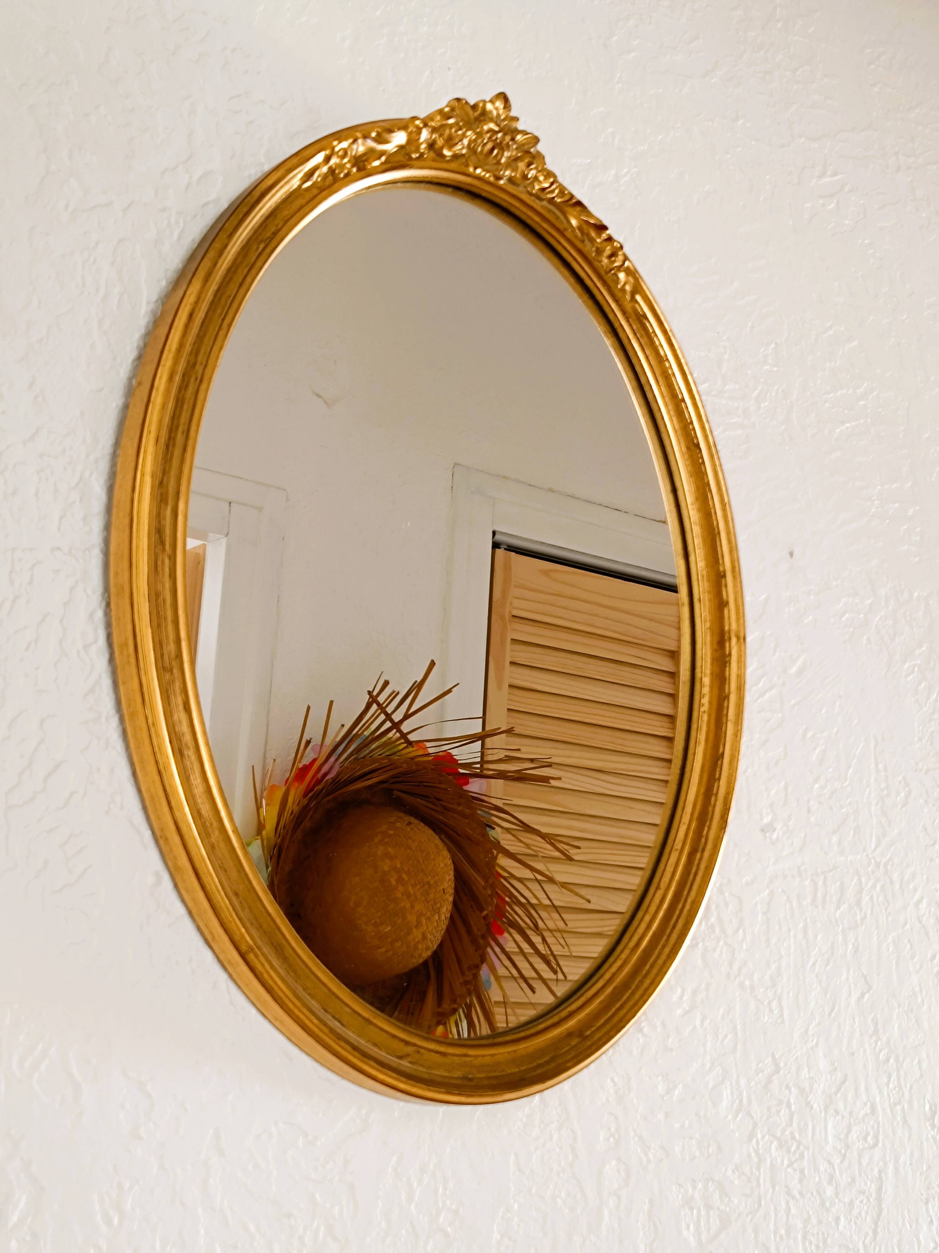 Antique oval-shaped gilded mirror