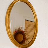 Antique oval-shaped gilded mirror