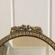 Oval mirror on psyche stand