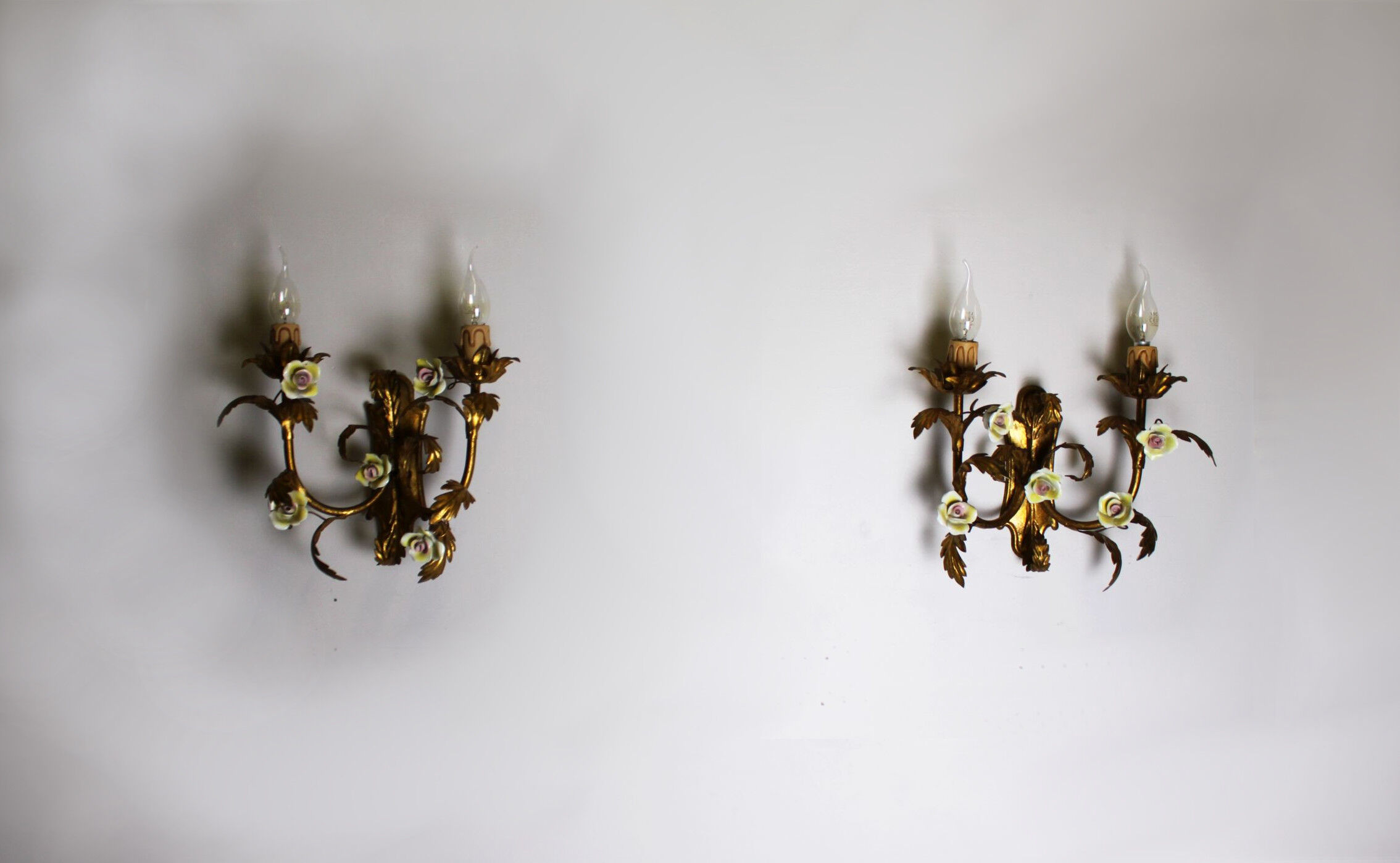 Pair of gold wall sconces with porcelain flowers