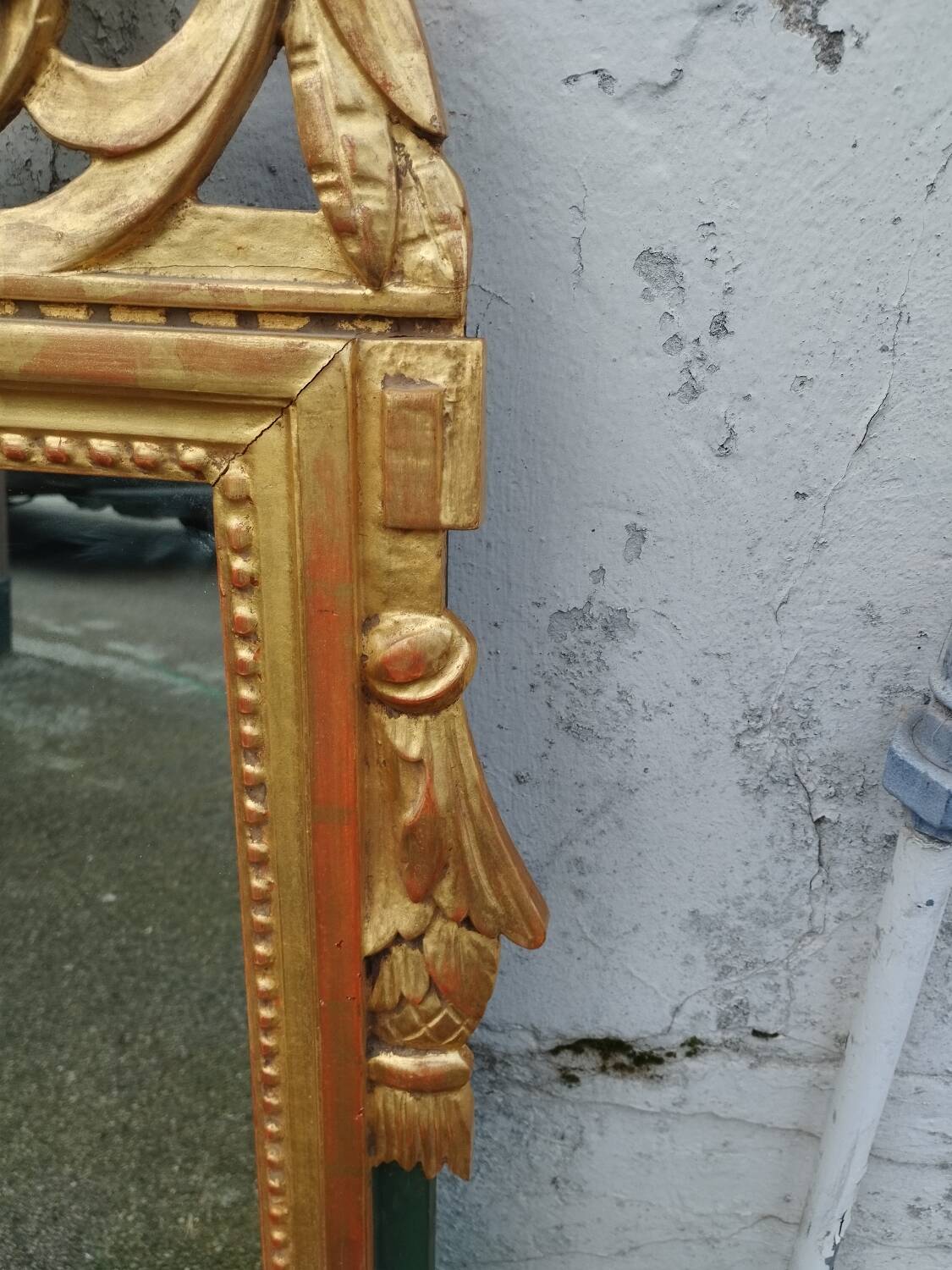 Antique gilded wooden mirror in Louis XVI style