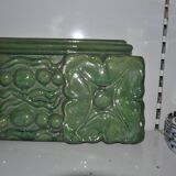 Green enamelled ceramic stove tile — finely sculpted Hungarian pattern from the late 19th century.