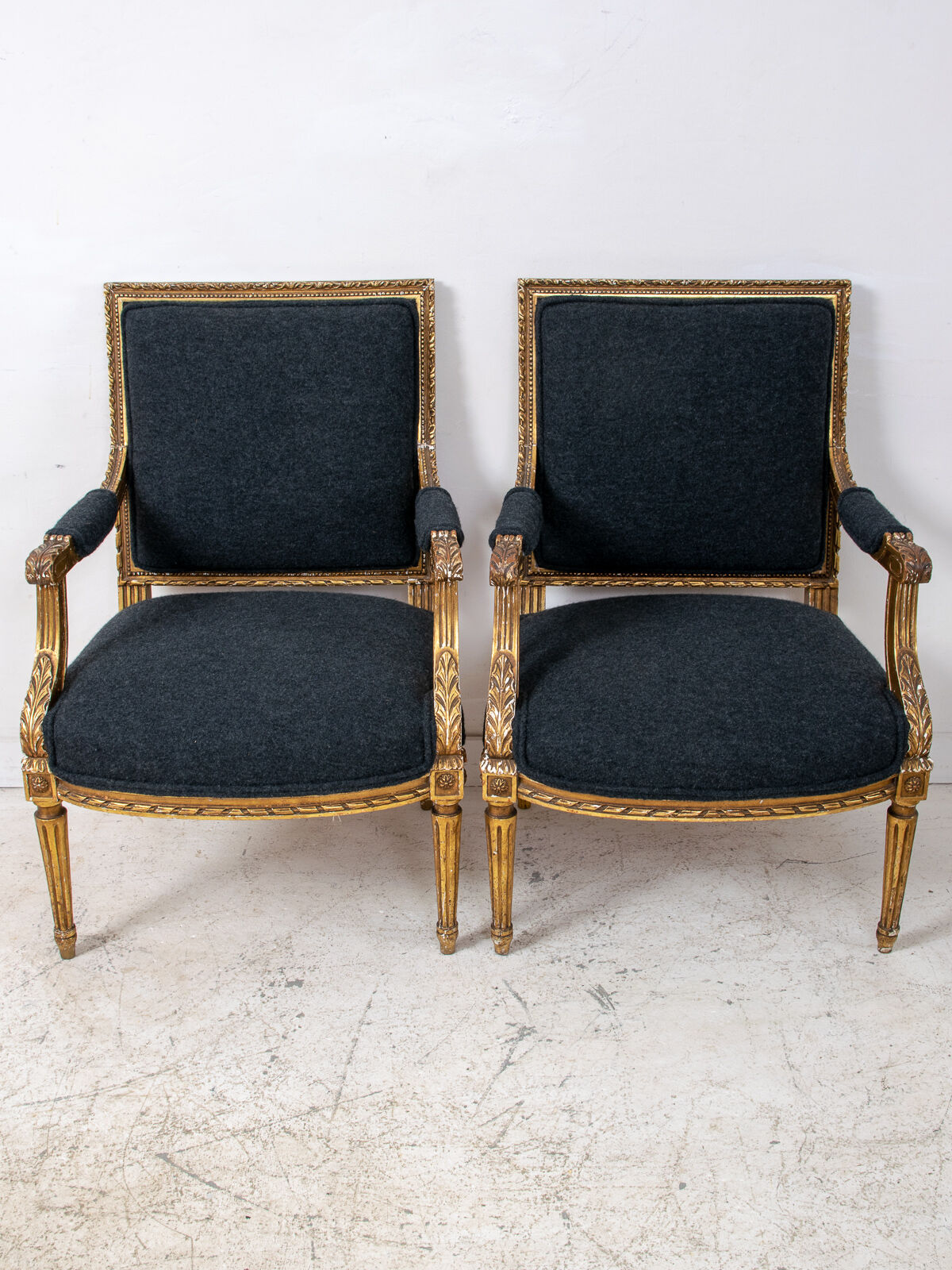 Pair of 19th century Louis XVI gilt armchairs newly re upholstered in holland and sherry fabric