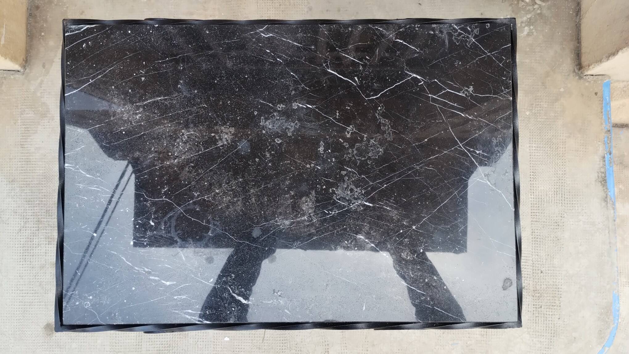 Wrought iron coffee table with black marble top