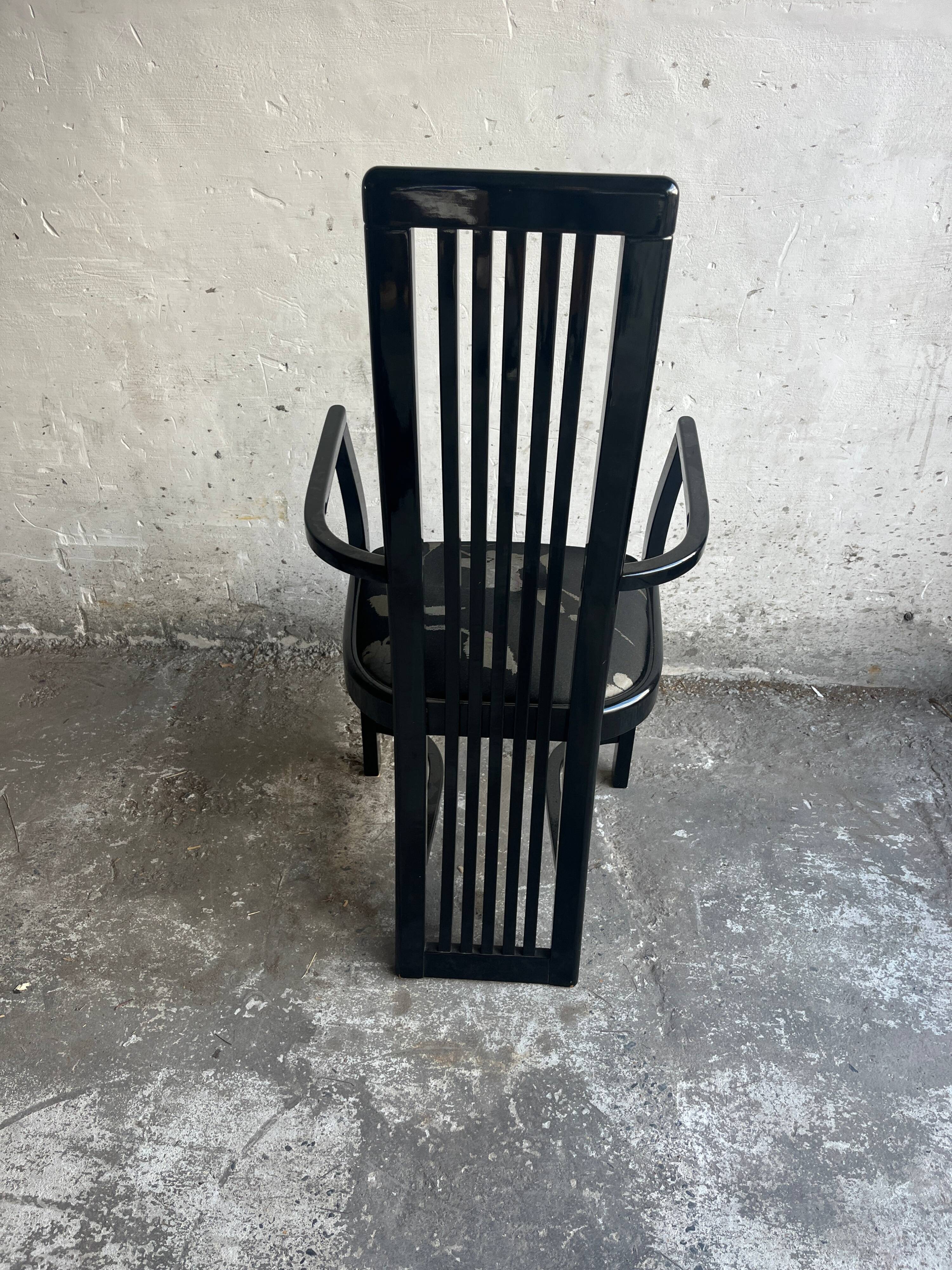 Set of 6 black lacquered wooden dining chairs with high backs and patterned fabric seats, 1980s.
