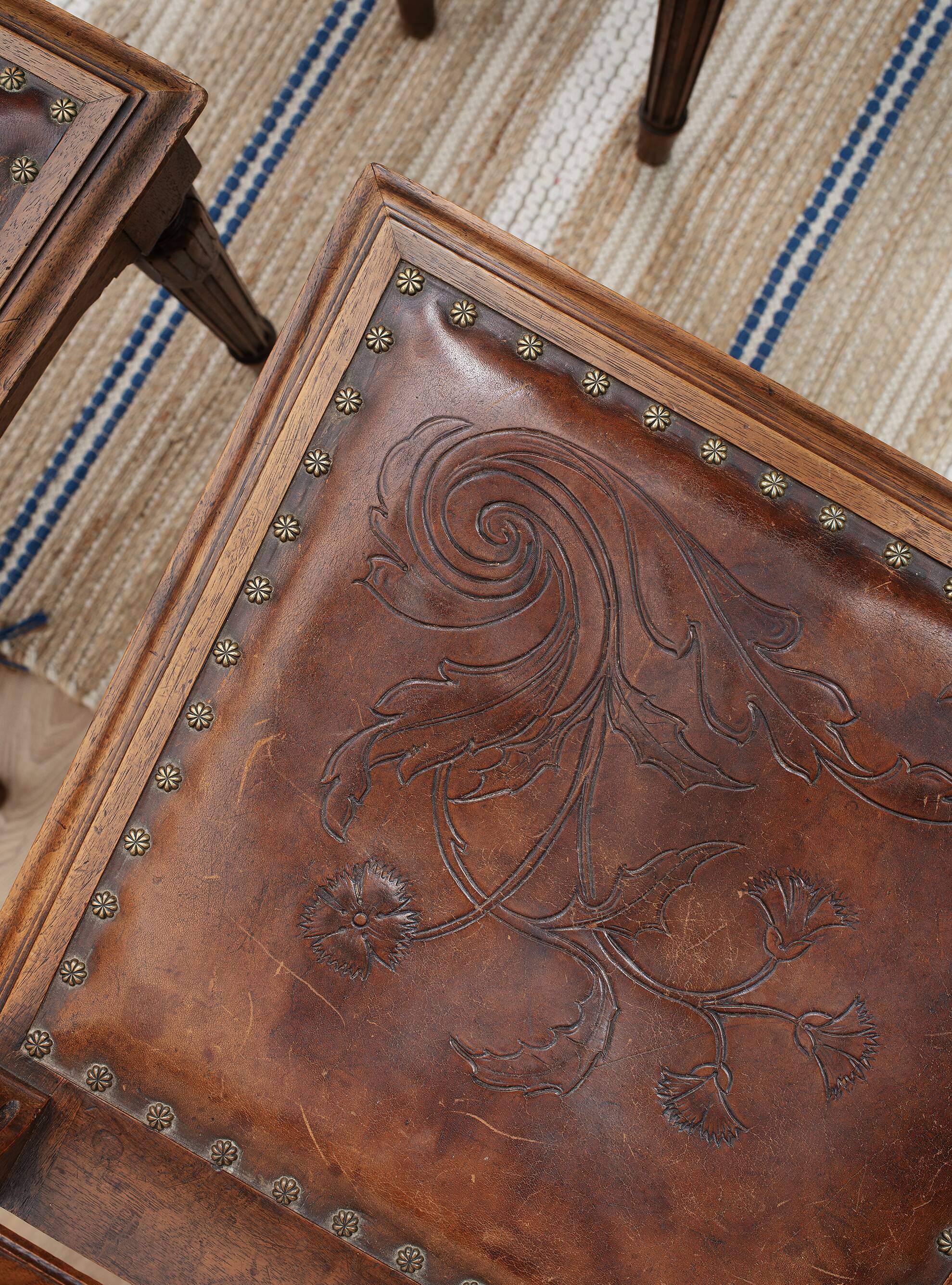 Set of 4 Louis XVI style chairs in carved wood and embossed leather.