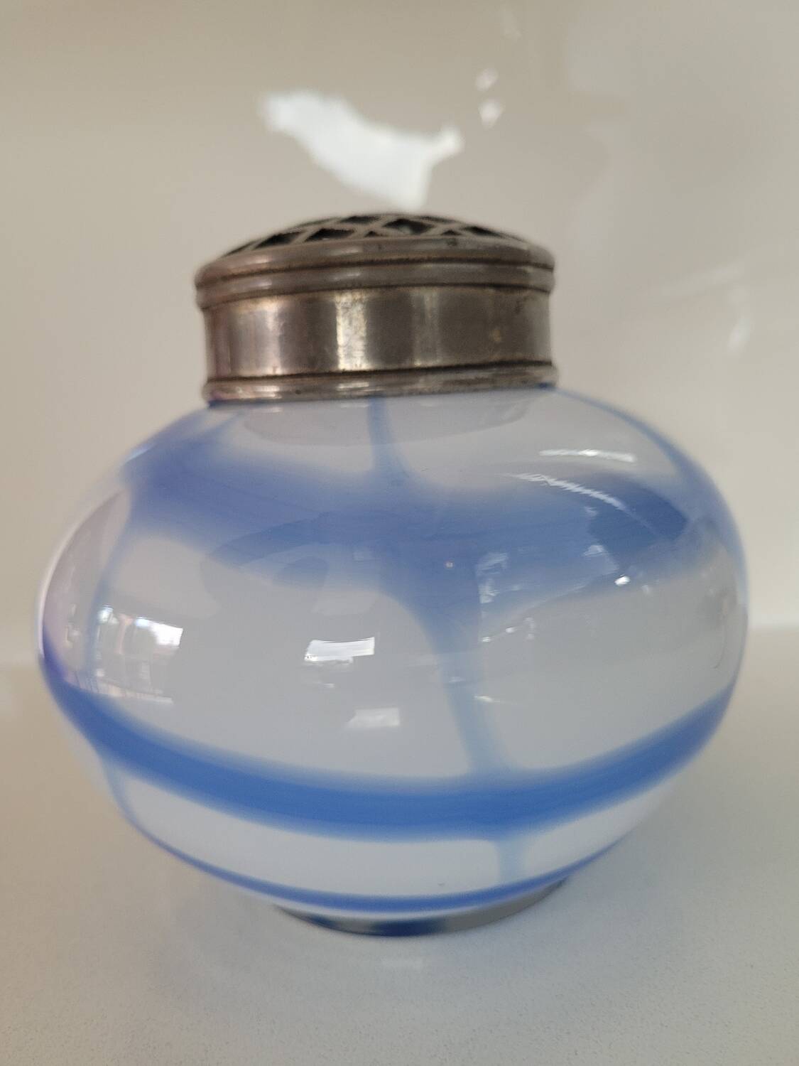 Old white and blue glass flower vase