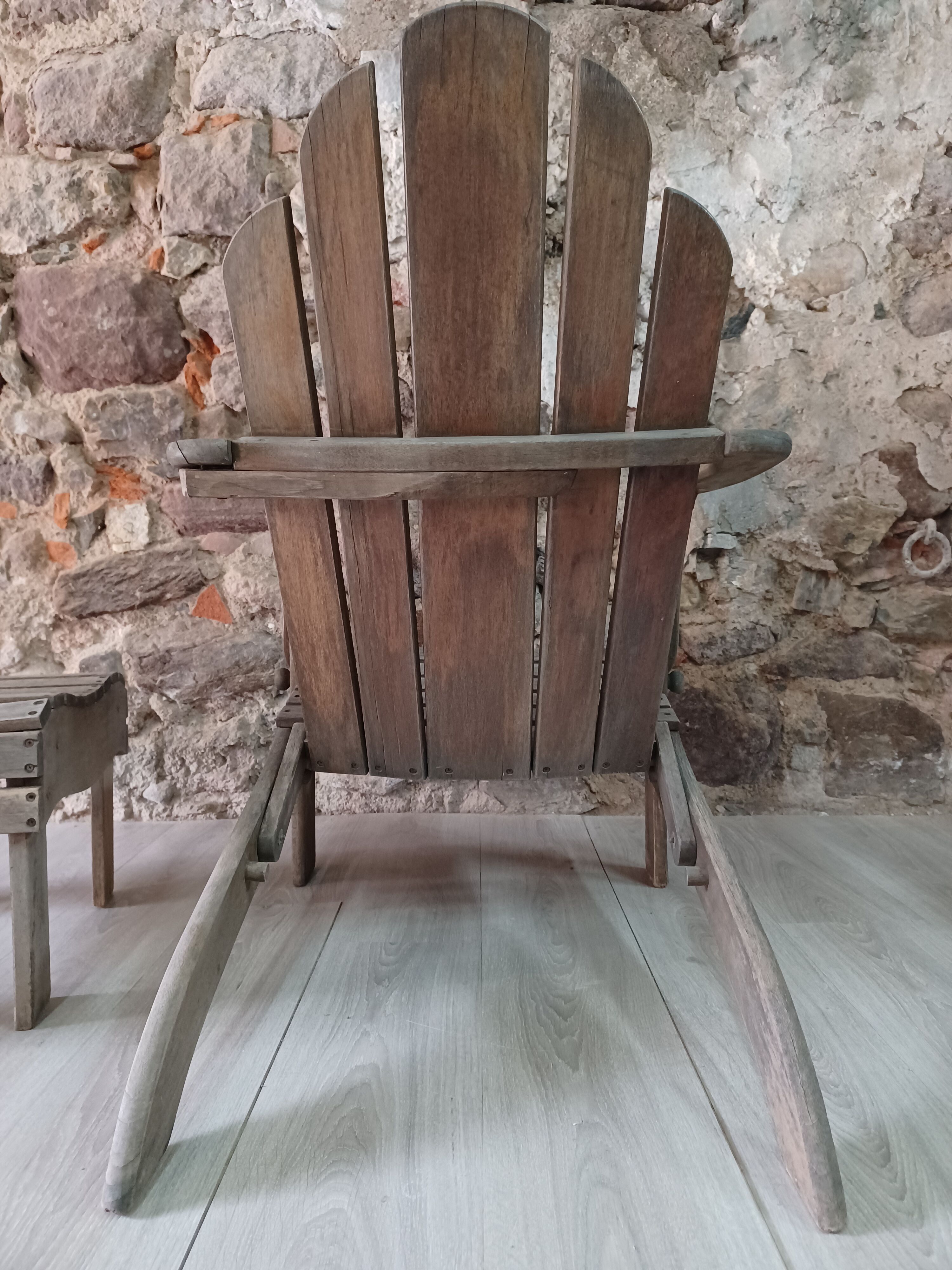 Ancient Adirondack armchair with footrest