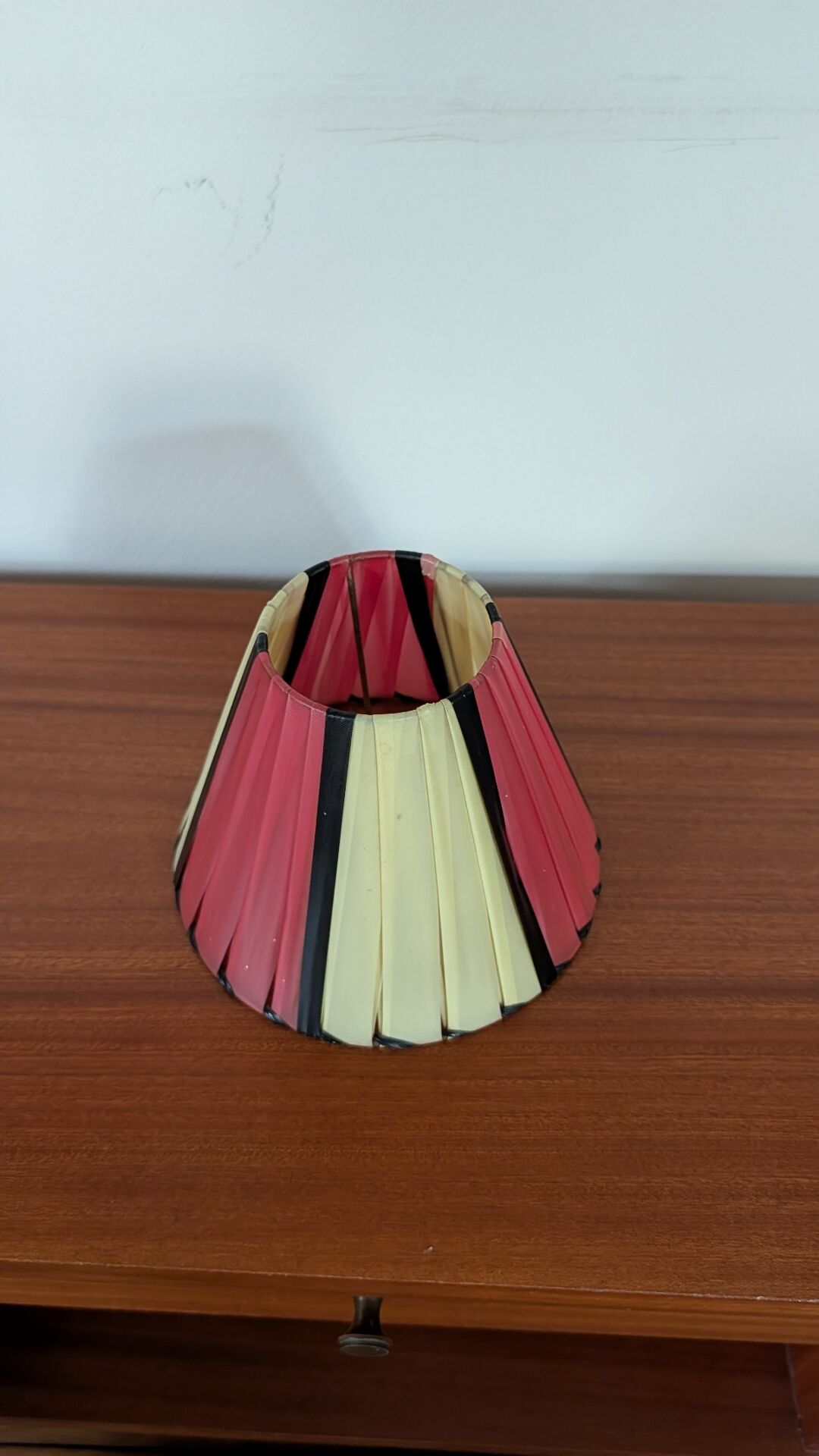 Pleated red and pale yellow plastic conical lampshade from the 1960s.